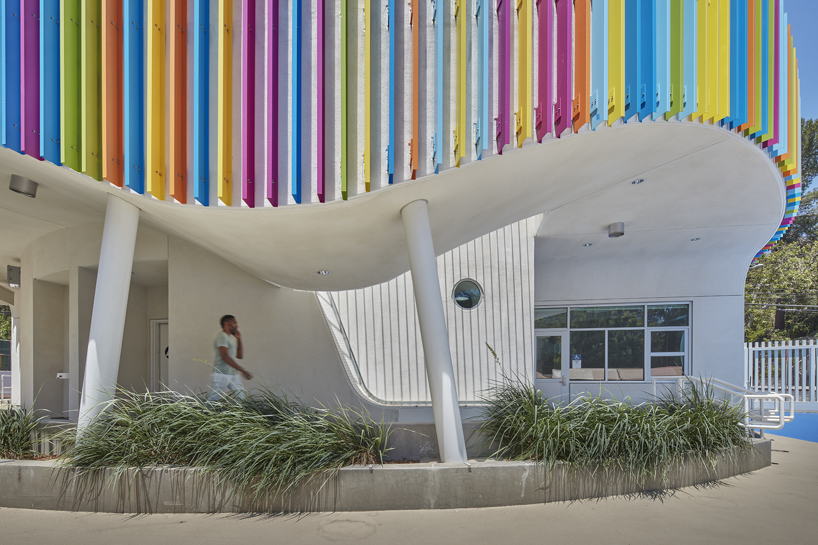 colored louvers wrap around los angeles elementary school's curved exterior by JFAK