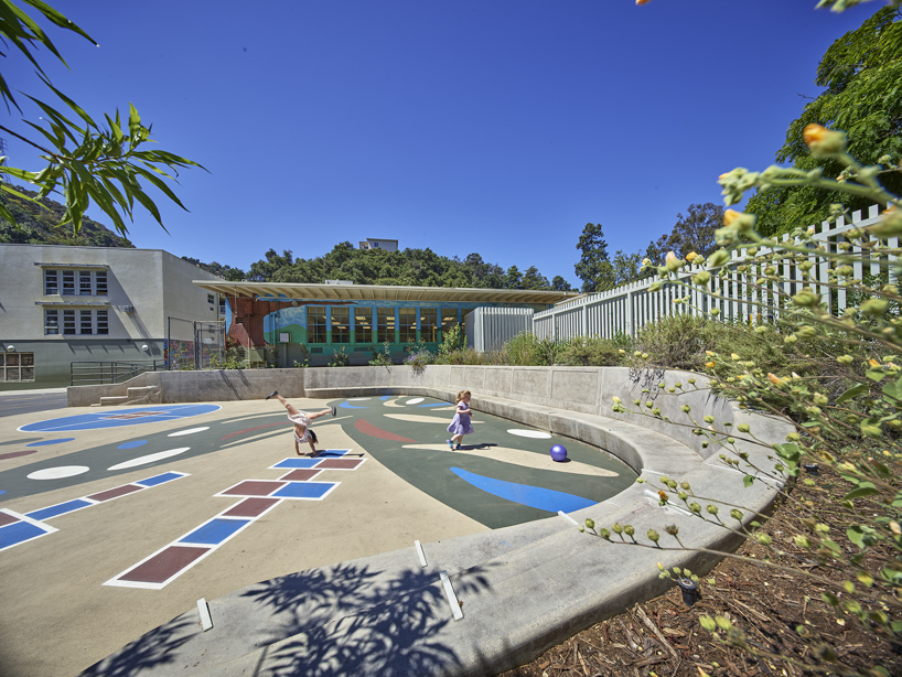 colored louvers wrap around los angeles elementary school's curved exterior by JFAK