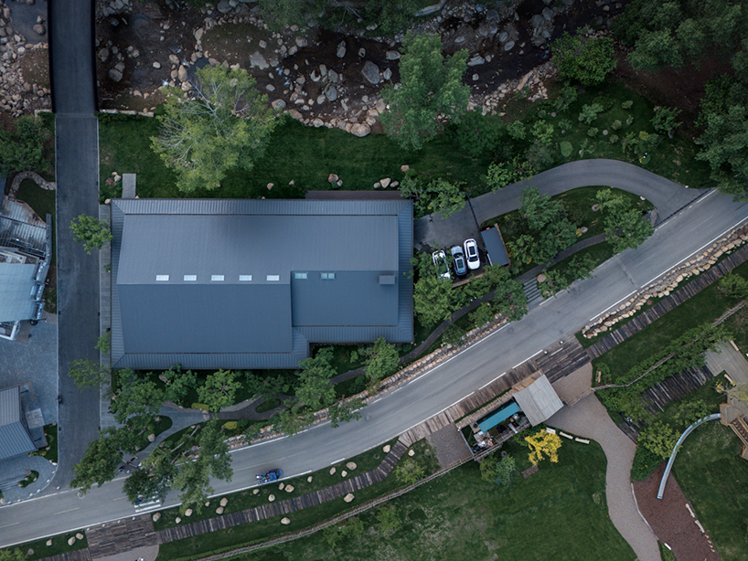 dark metal roof shapes community canteen beside mountain stream in china - 1