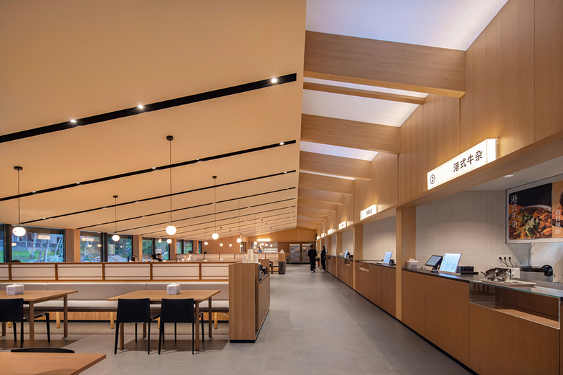 dark metal roof shapes community canteen beside mountain stream in china - 8