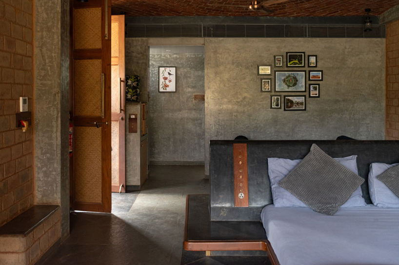 pond houses crafted from earth blocks float above land and water in india