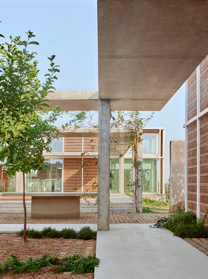 da.ch. crafts layered stone-paved landscape for casa tres patis in catalunya