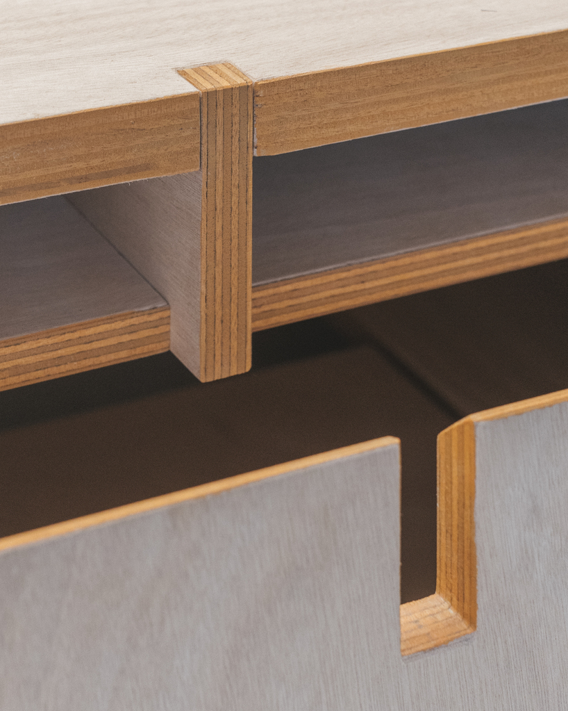 modular wooden table reforms into exhibition platform within ceramic workshop by AACM