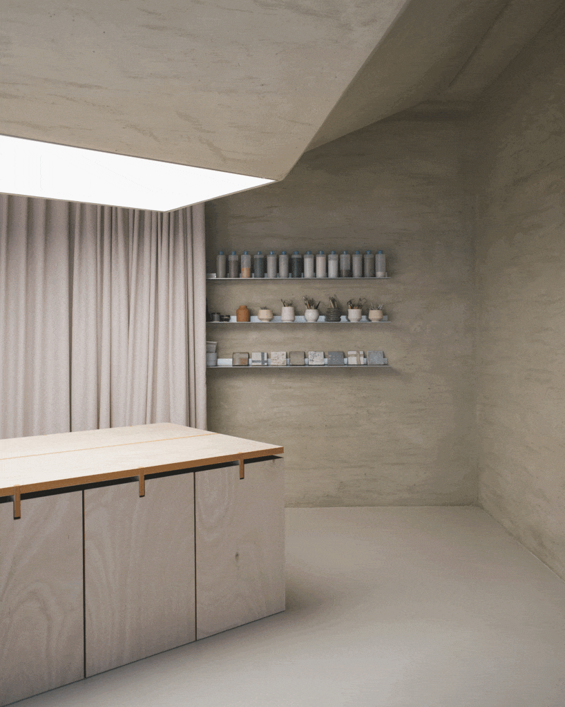 modular wooden table reforms into exhibition platform within ceramic workshop by AACM