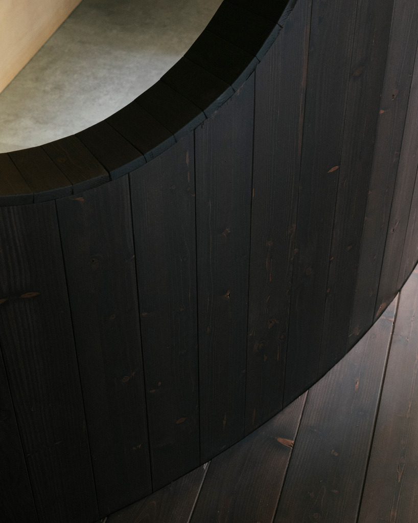 perforated wooden screens filter light and shadow within milan ceramic workshop - 11