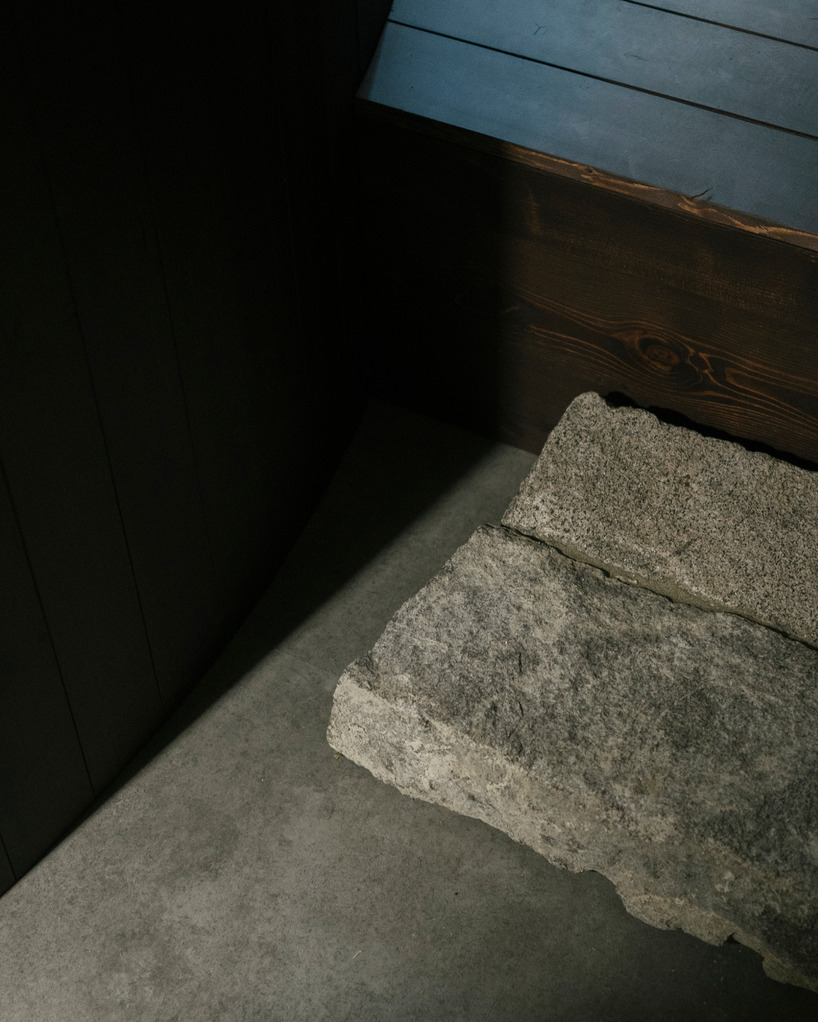 perforated wooden screens filter light and shadow within milan ceramic workshop - 12