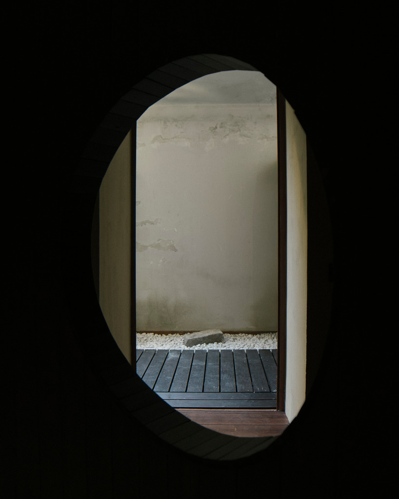 perforated wooden screens filter light and shadow within milan ceramic workshop - 8