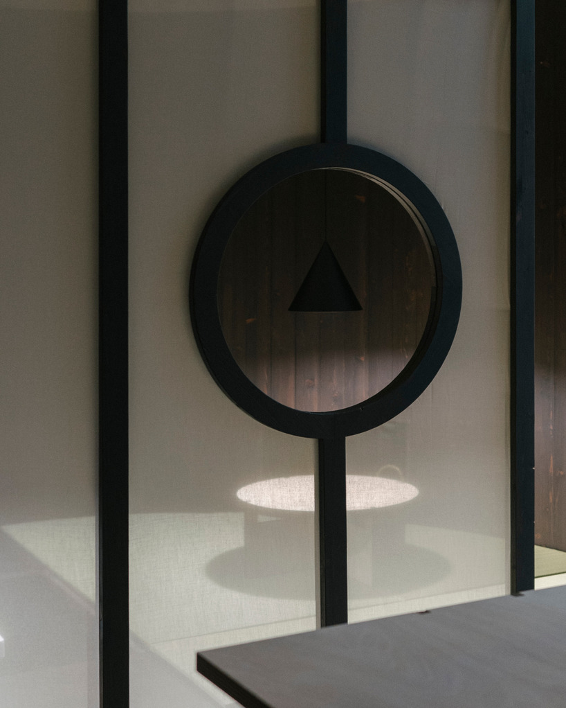 perforated wooden screens filter light and shadow within milan ceramic workshop - 9