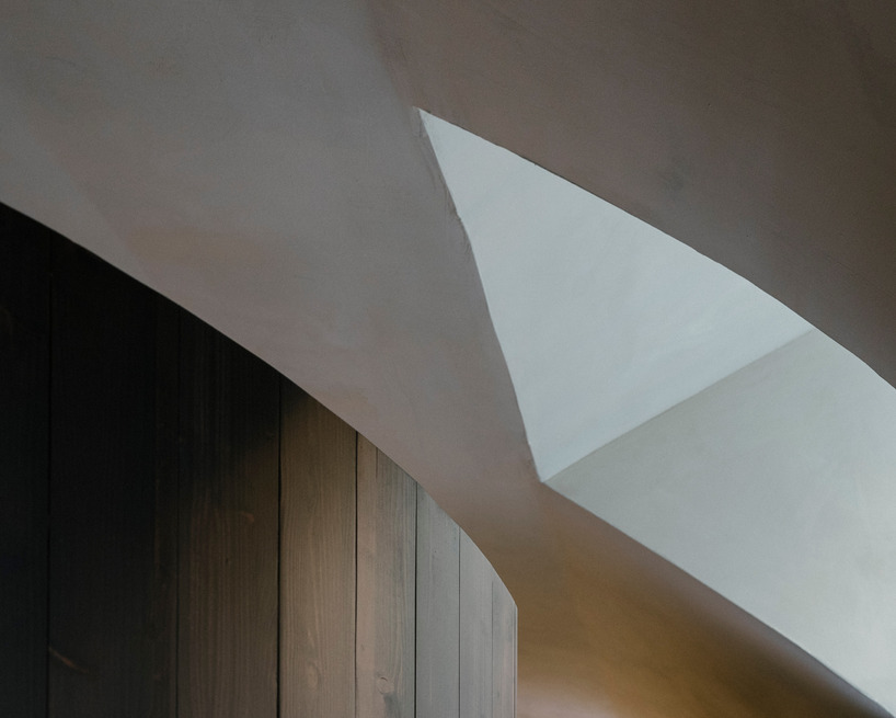 perforated wooden screens filter light and shadow within milan ceramic workshop - 10