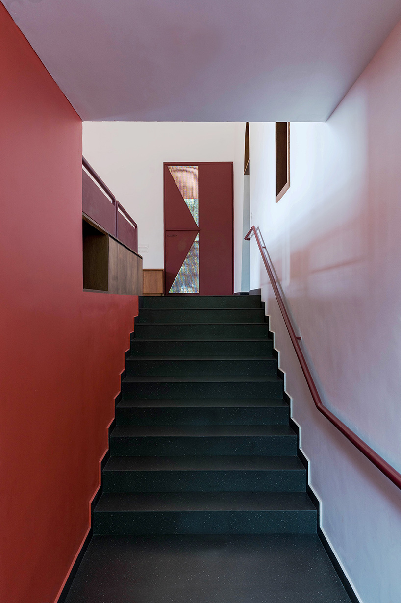 geometric red wall segments emerge from saba house's white body in indian highlands
