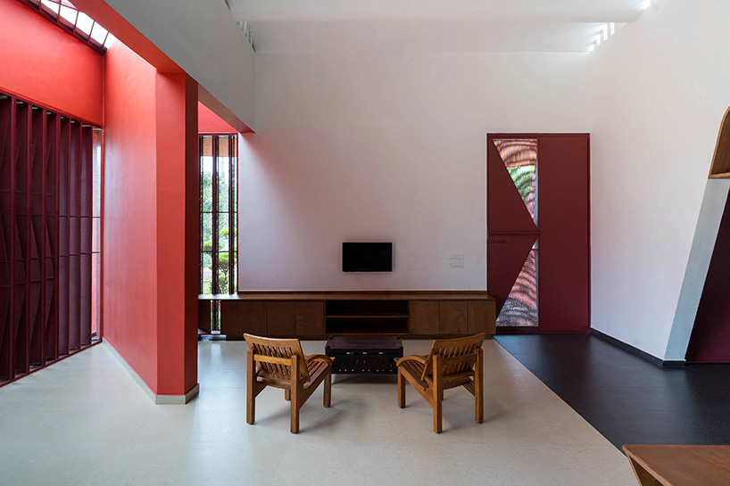 geometric red wall segments emerge from saba house's white body in indian highlands