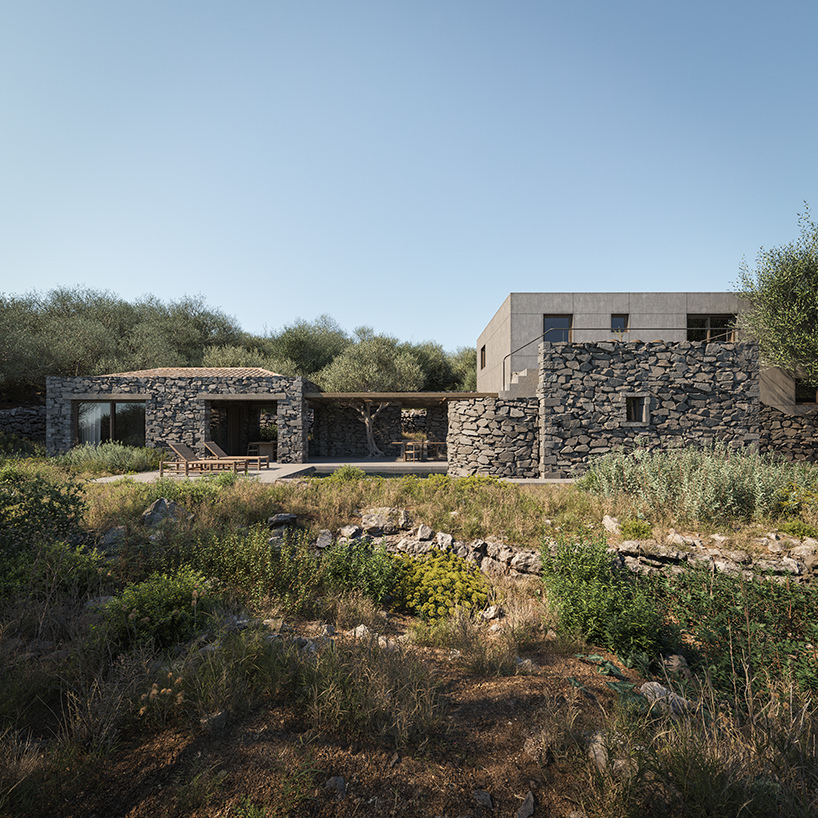 rough stone textures interplay with smooth gray cement for enigma project in paxos island