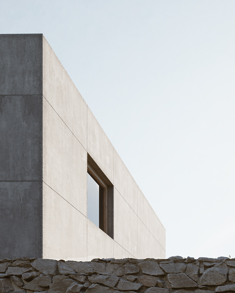 rough stone textures interplay with smooth gray cement for enigma project in paxos island