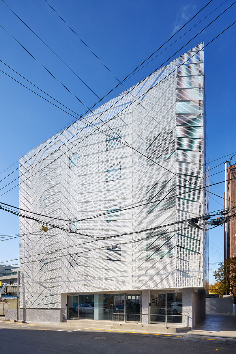 perforated metal panels reframe building's exterior into responsive facade system in seoul