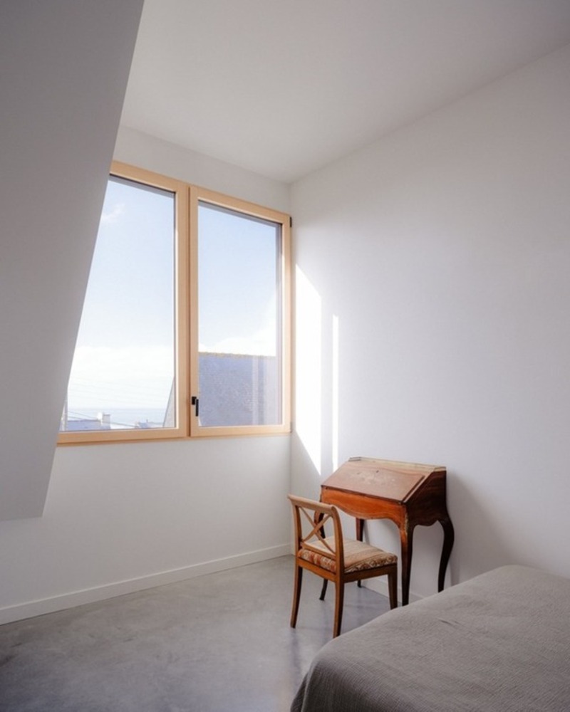 dark wooden slats coat house in saint-malo by maab architectes, sitting on stone plinth