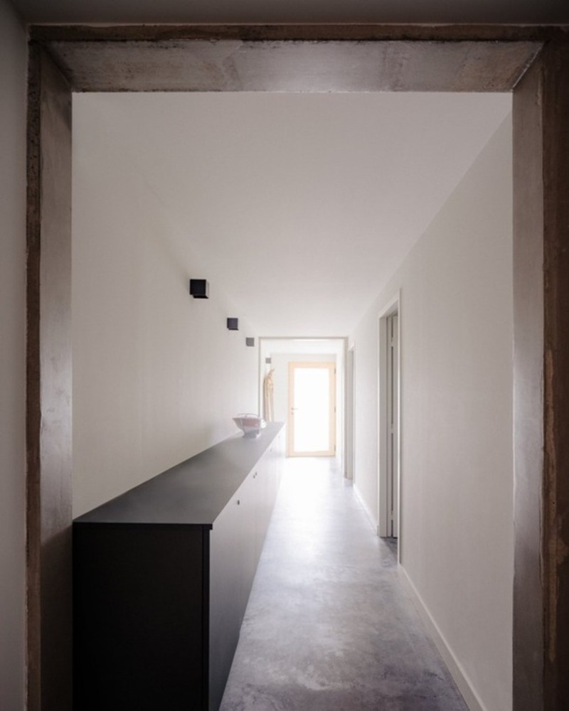 dark wooden slats coat house in saint-malo by maab architectes, sitting on stone plinth