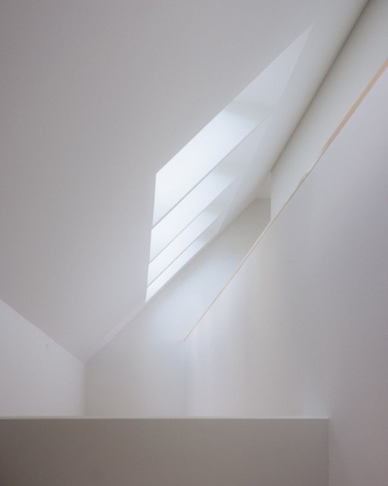 dark wooden slats coat house in saint-malo by maab architectes, sitting on stone plinth