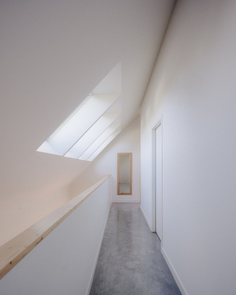dark wooden slats coat house in saint-malo by maab architectes, sitting on stone plinth