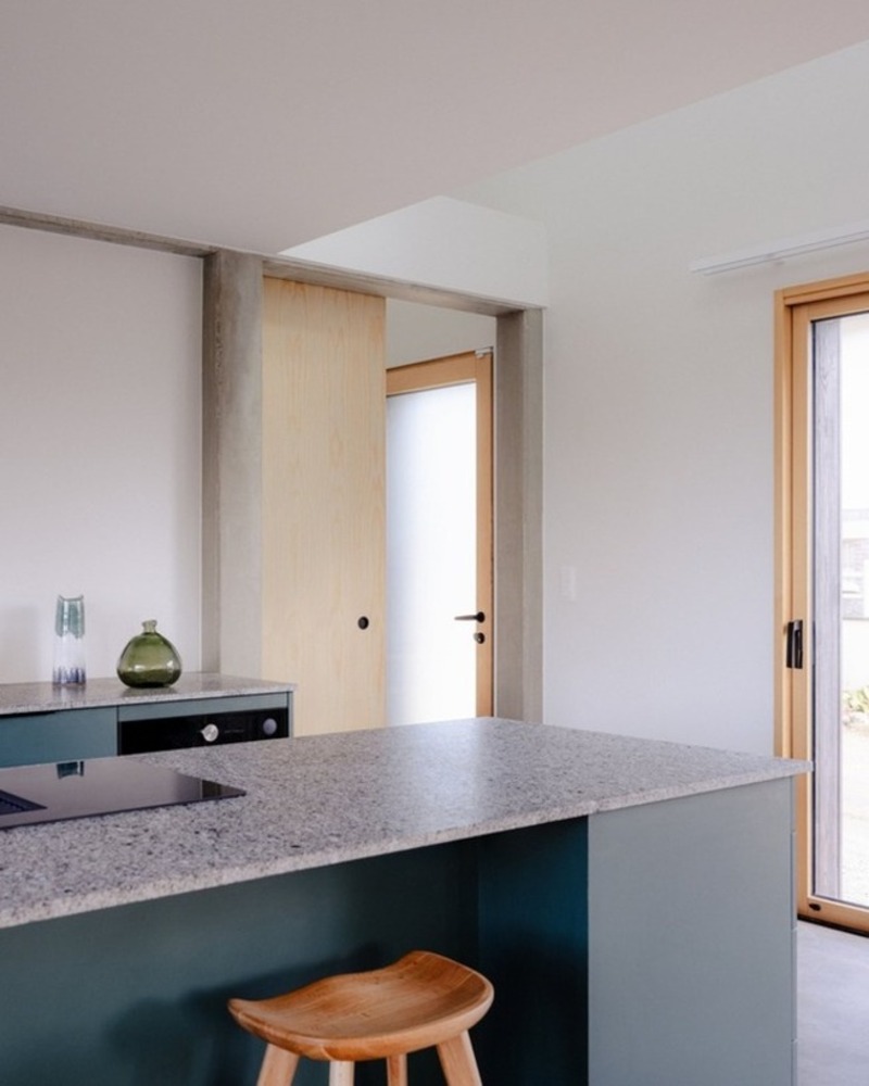 dark wooden slats coat house in saint-malo by maab architectes, sitting on stone plinth