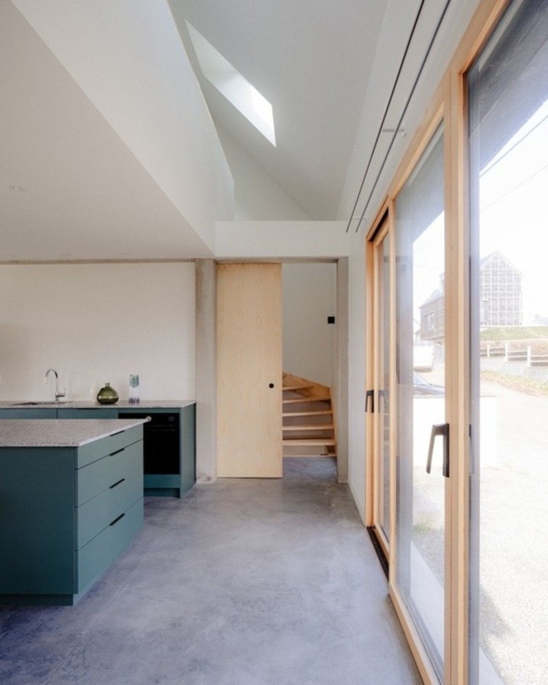 dark wooden slats coat house in saint-malo by maab architectes, sitting on stone plinth