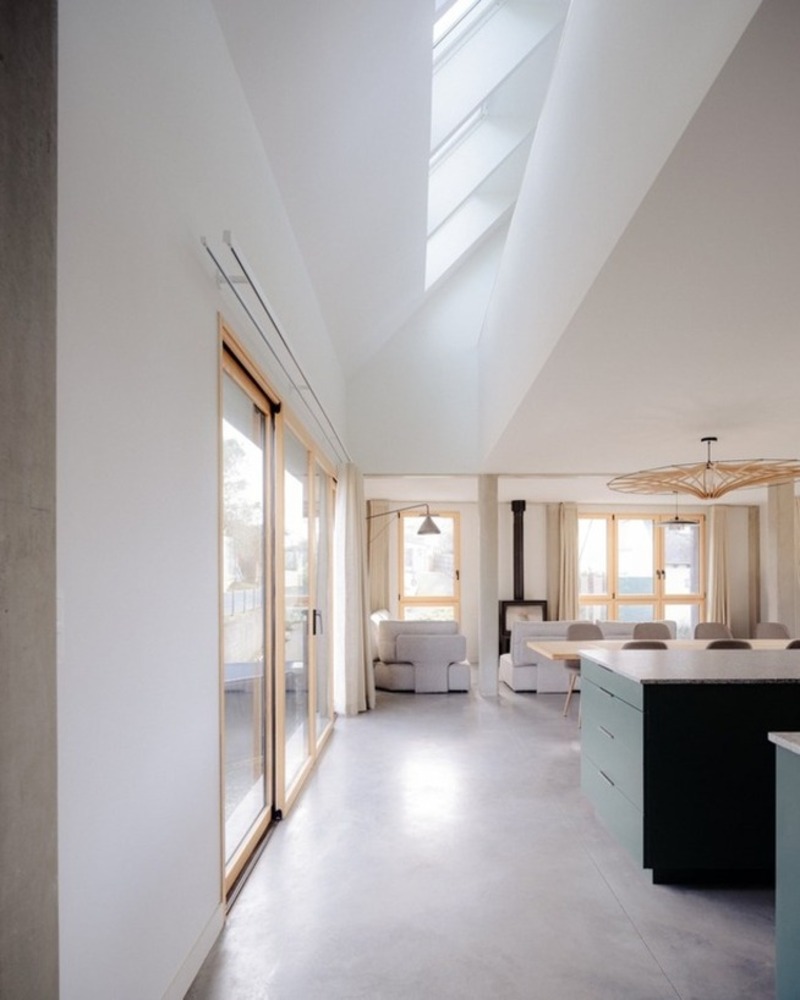 dark wooden slats coat house in saint-malo by maab architectes, sitting on stone plinth