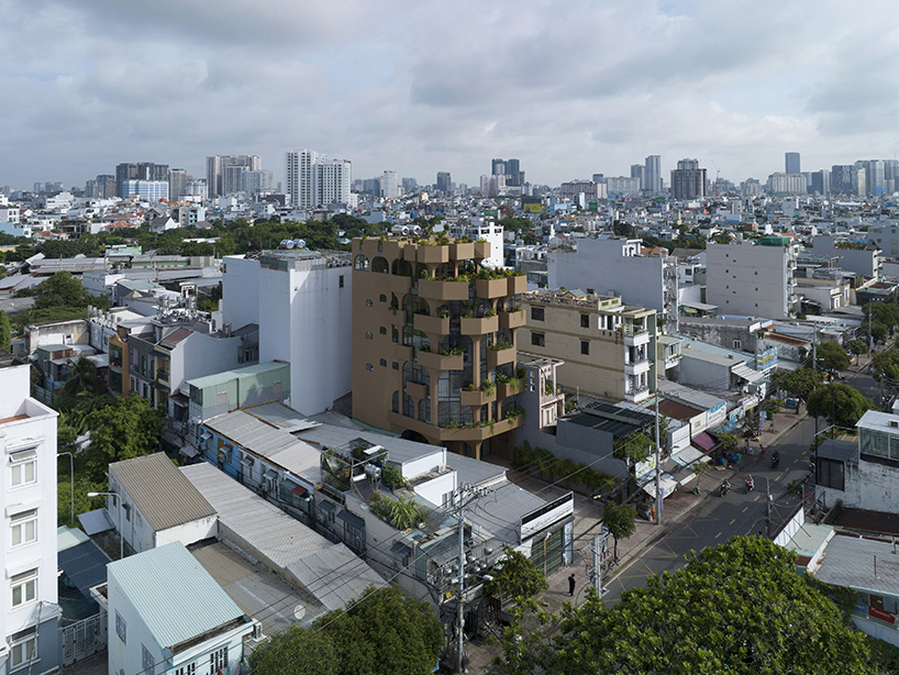 mixed-use unit's curved and vaulted volumes by room+ shape vertical garden in vietnam