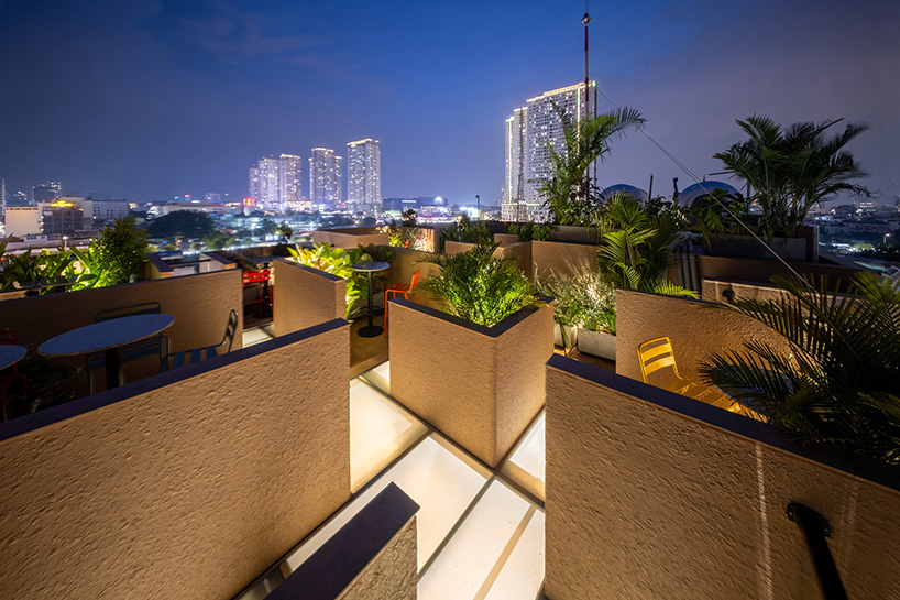 mixed-use unit's curved and vaulted volumes by room+ shape vertical garden in vietnam