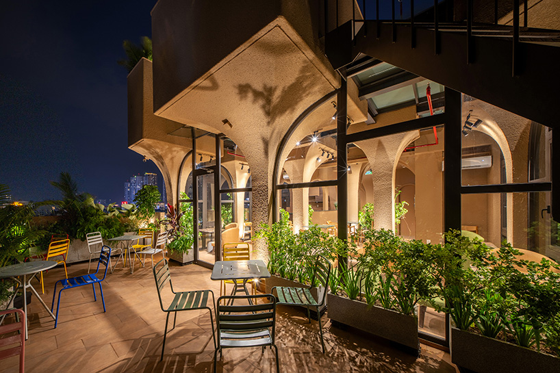 mixed-use unit's curved and vaulted volumes by room+ shape vertical garden in vietnam