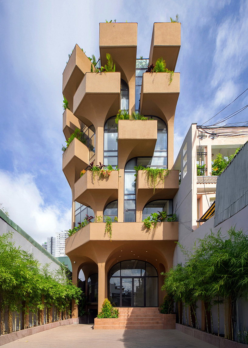 mixed-use unit's curved and vaulted volumes by room+ shape vertical garden in vietnam