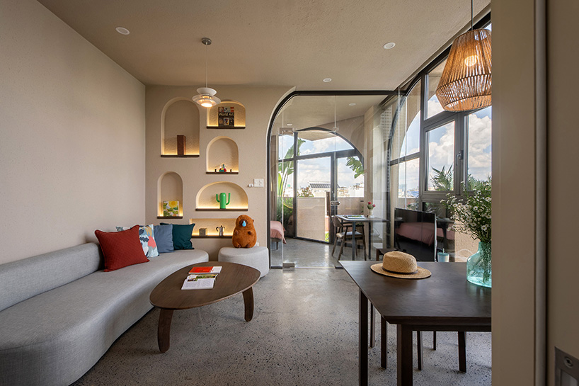 mixed-use unit's curved and vaulted volumes by room+ shape vertical garden in vietnam