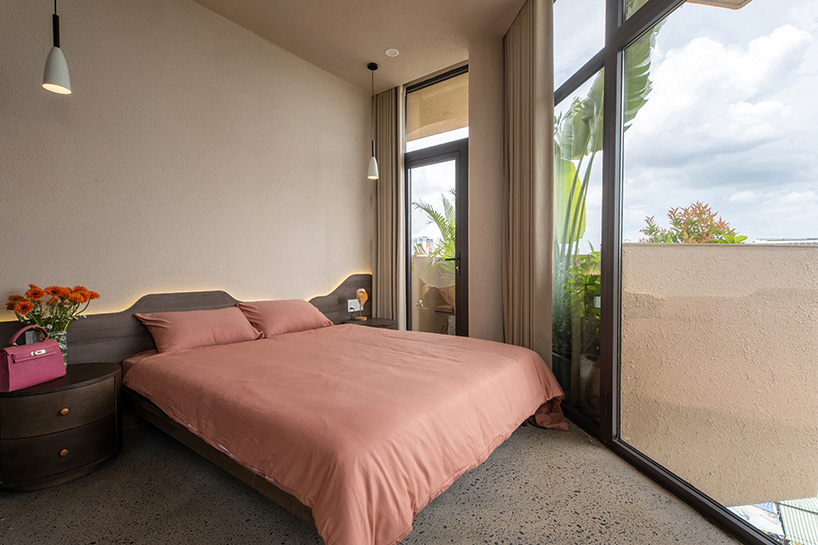 mixed-use unit's curved and vaulted volumes by room+ shape vertical garden in vietnam