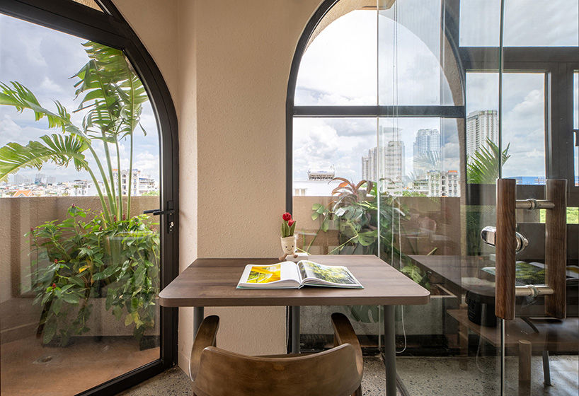 mixed-use unit's curved and vaulted volumes by room+ shape vertical garden in vietnam
