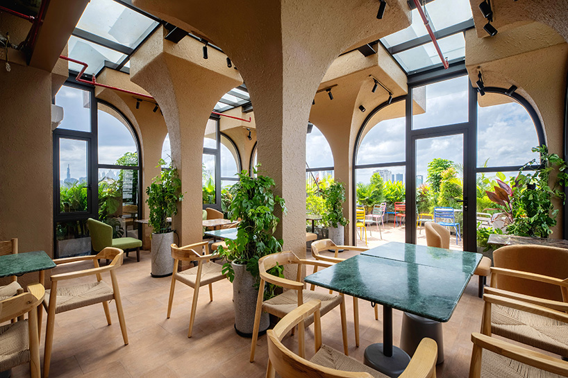 mixed-use unit's curved and vaulted volumes by room+ shape vertical garden in vietnam