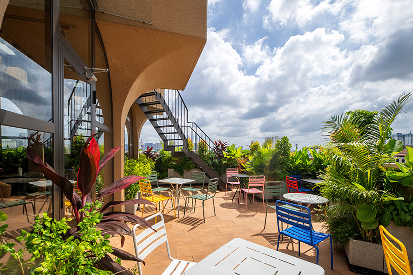mixed-use unit's curved and vaulted volumes by room+ shape vertical garden in vietnam