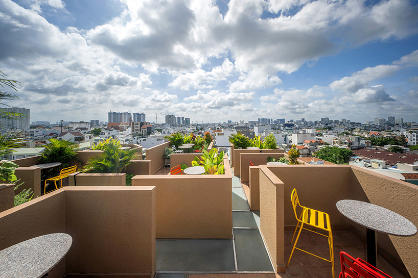 mixed-use unit's curved and vaulted volumes by room+ shape vertical garden in vietnam