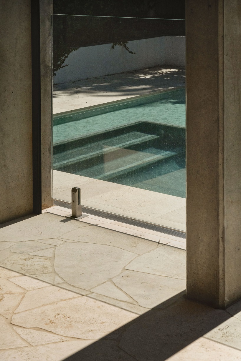 bold concrete frame by george kouparitsas reshapes pre-war cottage's facade in australia