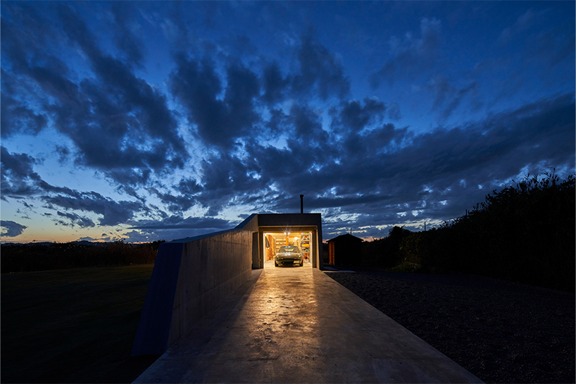 concrete isumi villa by takeshi hosaka architects organically spreads over land in japan