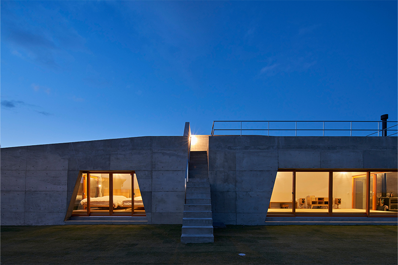 concrete isumi villa by takeshi hosaka architects organically spreads over land in japan