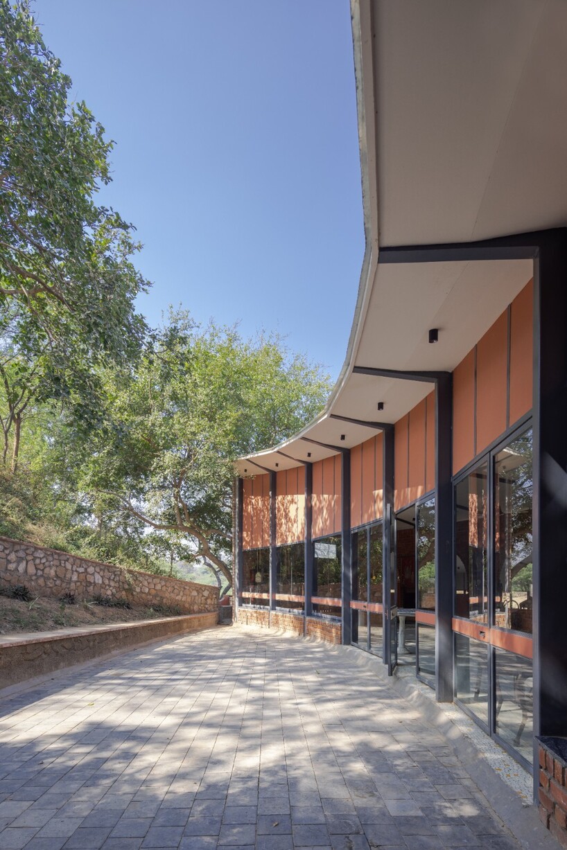curved canopy shelters stepped house-gallery hybrid by milind shivani in india