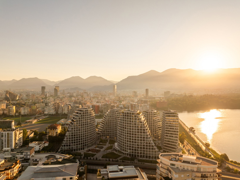 JA joubert architecture sculpts undulating lakefront district following sloped terrain in tirana