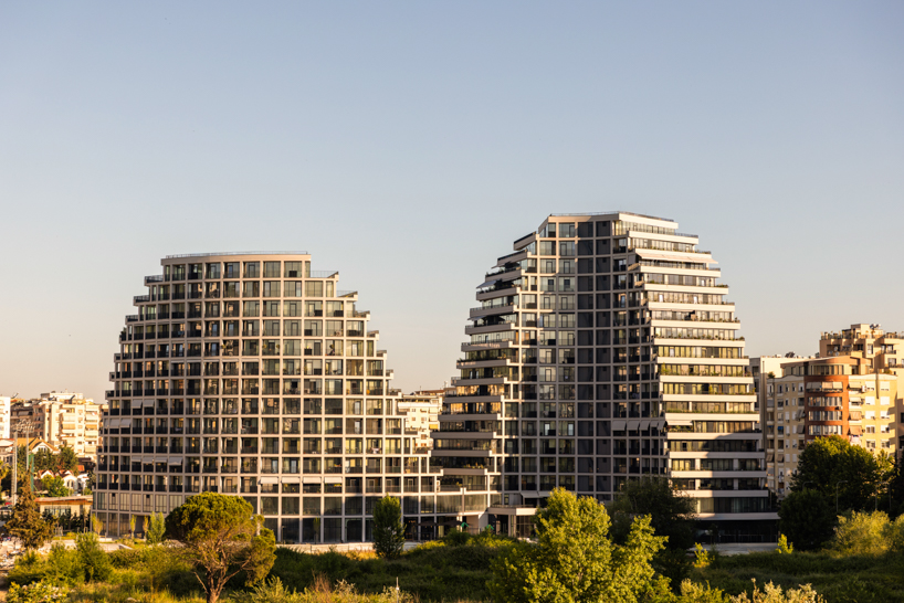 JA joubert architecture sculpts undulating lakefront district following sloped terrain in tirana