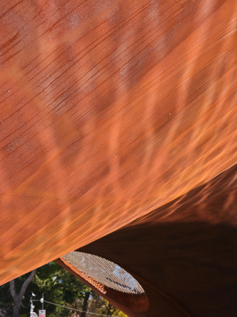 slender steel bridge with integrated net seating expands over foša port in croatia