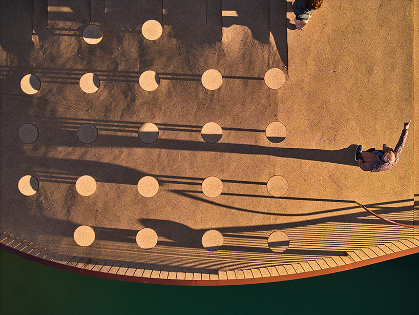 slender steel bridge with integrated net seating expands over foša port in croatia