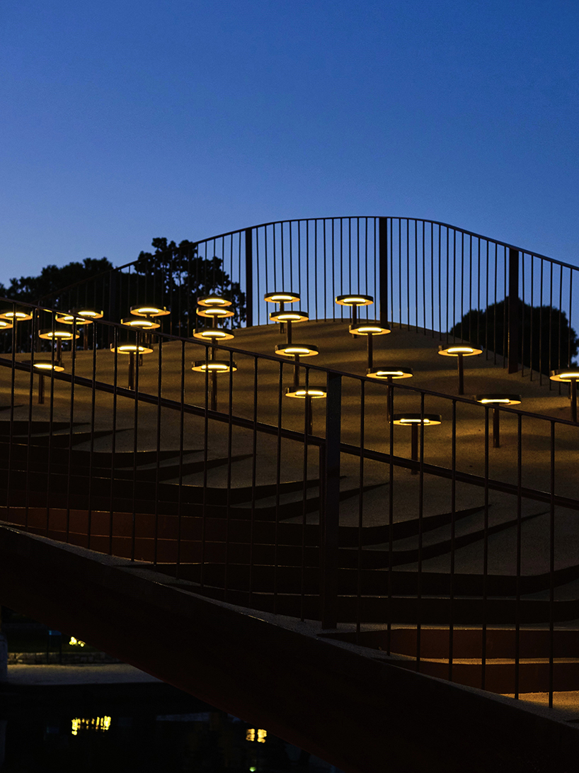 slender steel bridge with integrated net seating expands over foša port in croatia