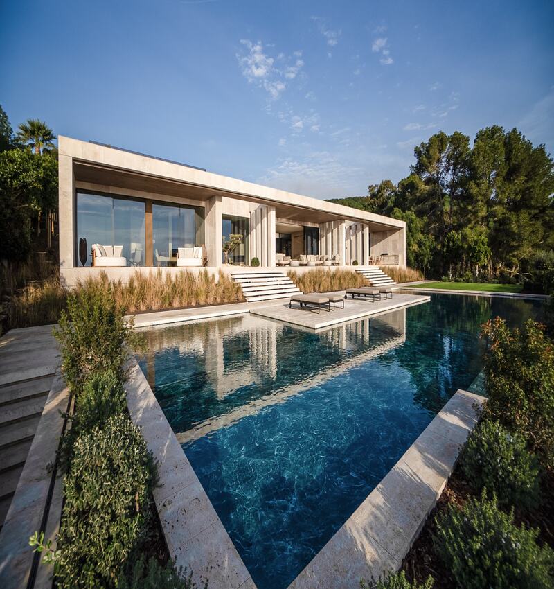 ARK architects elevates villa tai on stone podium framing views of mediterranean sea