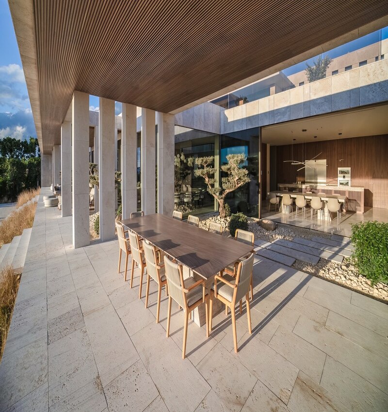 ARK architects elevates villa tai on stone podium framing views of mediterranean sea