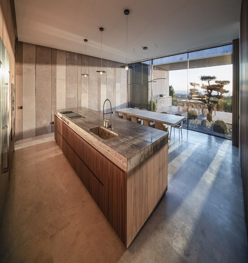 ARK architects elevates villa tai on stone podium framing views of mediterranean sea