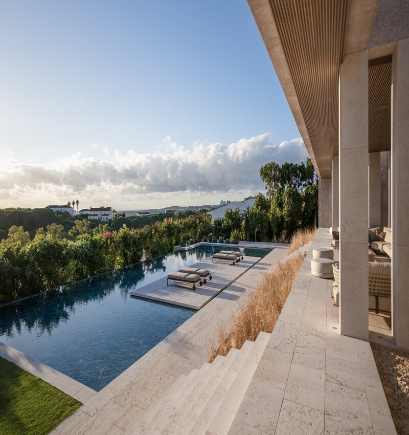 ARK architects elevates villa tai on stone podium framing views of mediterranean sea
