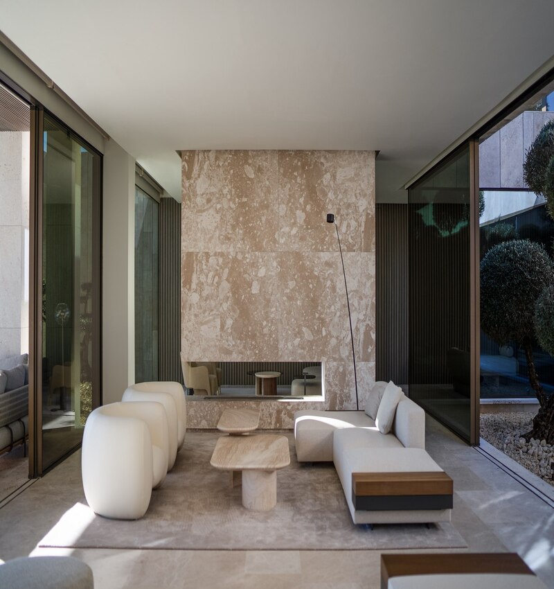 ARK architects elevates villa tai on stone podium framing views of mediterranean sea