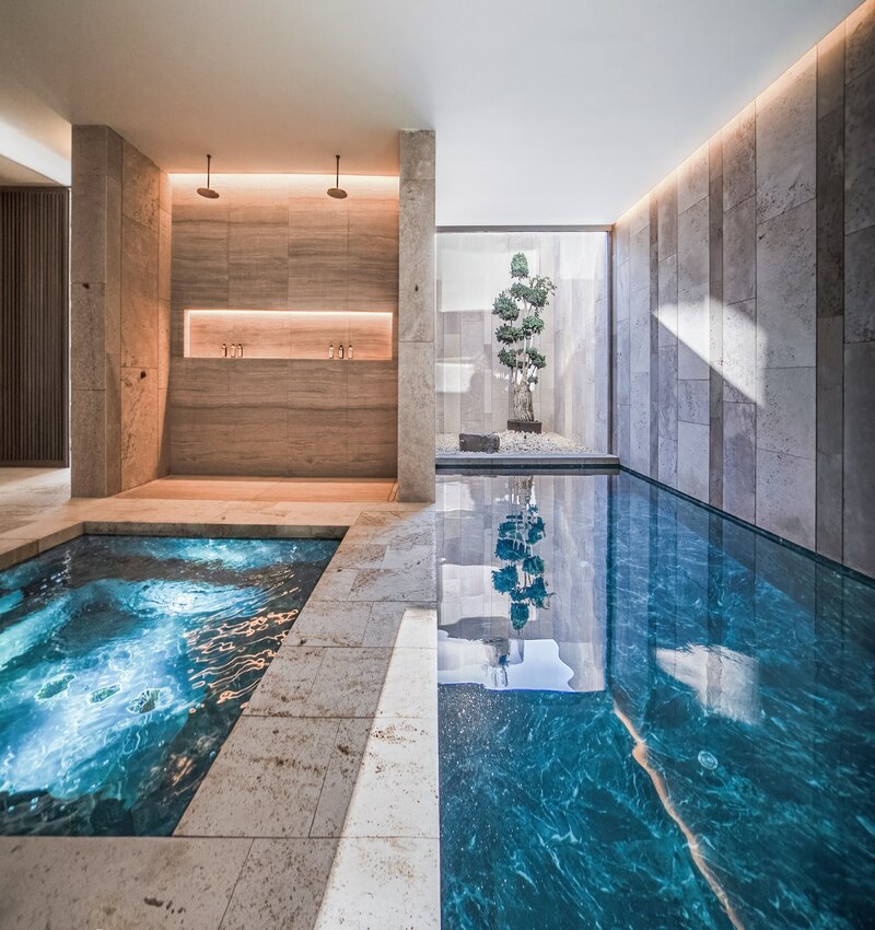 ARK architects elevates villa tai on stone podium framing views of mediterranean sea